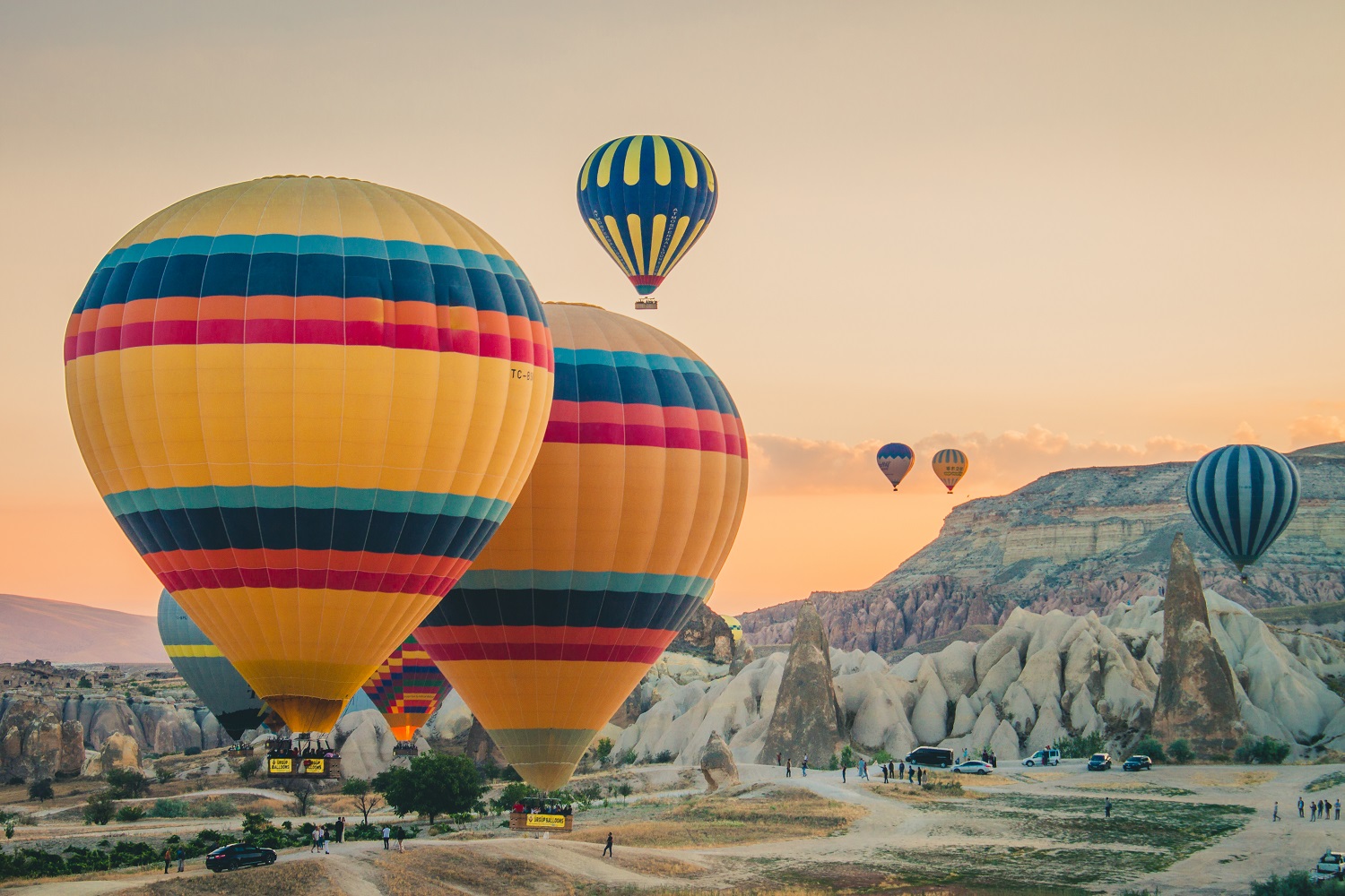 multi-colored-hot-air-balloons-flying-land